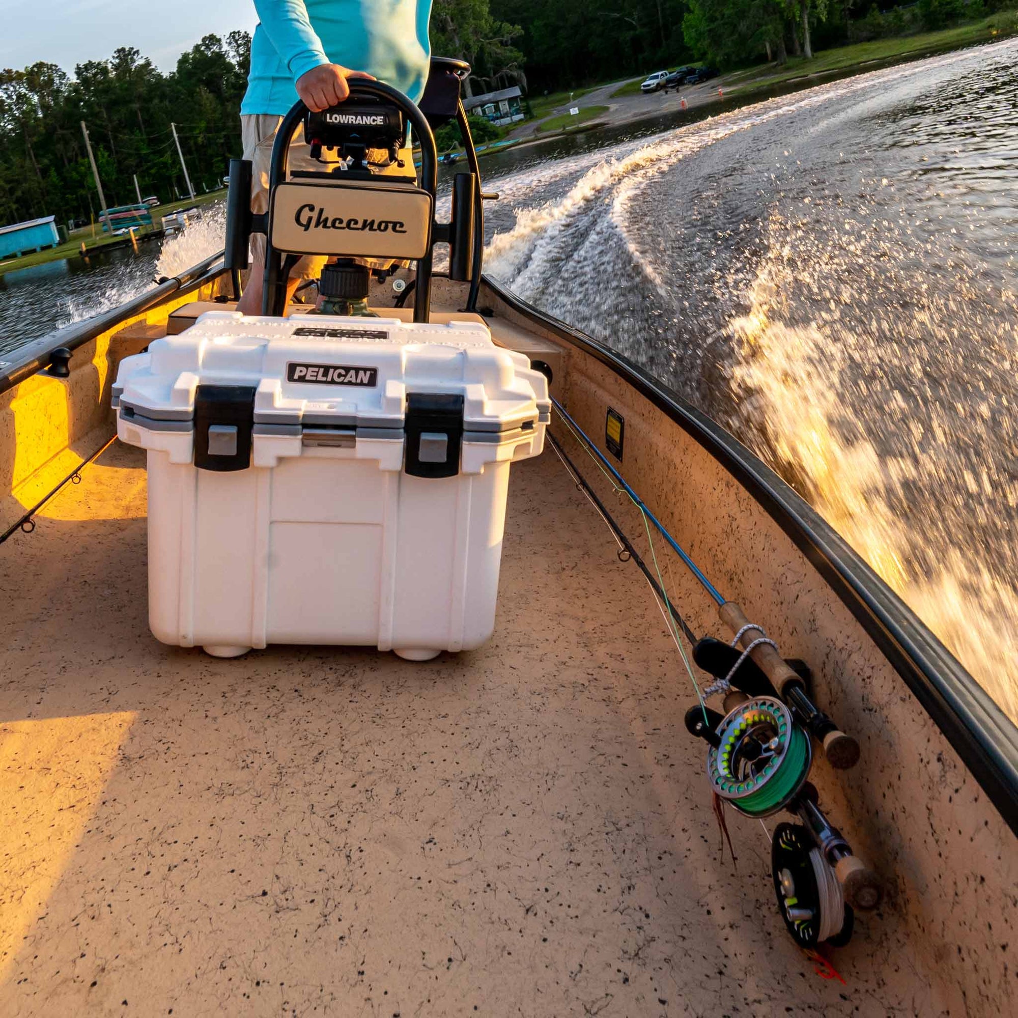 White / Grey Pelican Elite Cooler on a boat with fishing rod