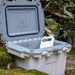 White / Grey 30QT Pelican Elite Cooler being used outside with a 2lb Pelican Ice pack