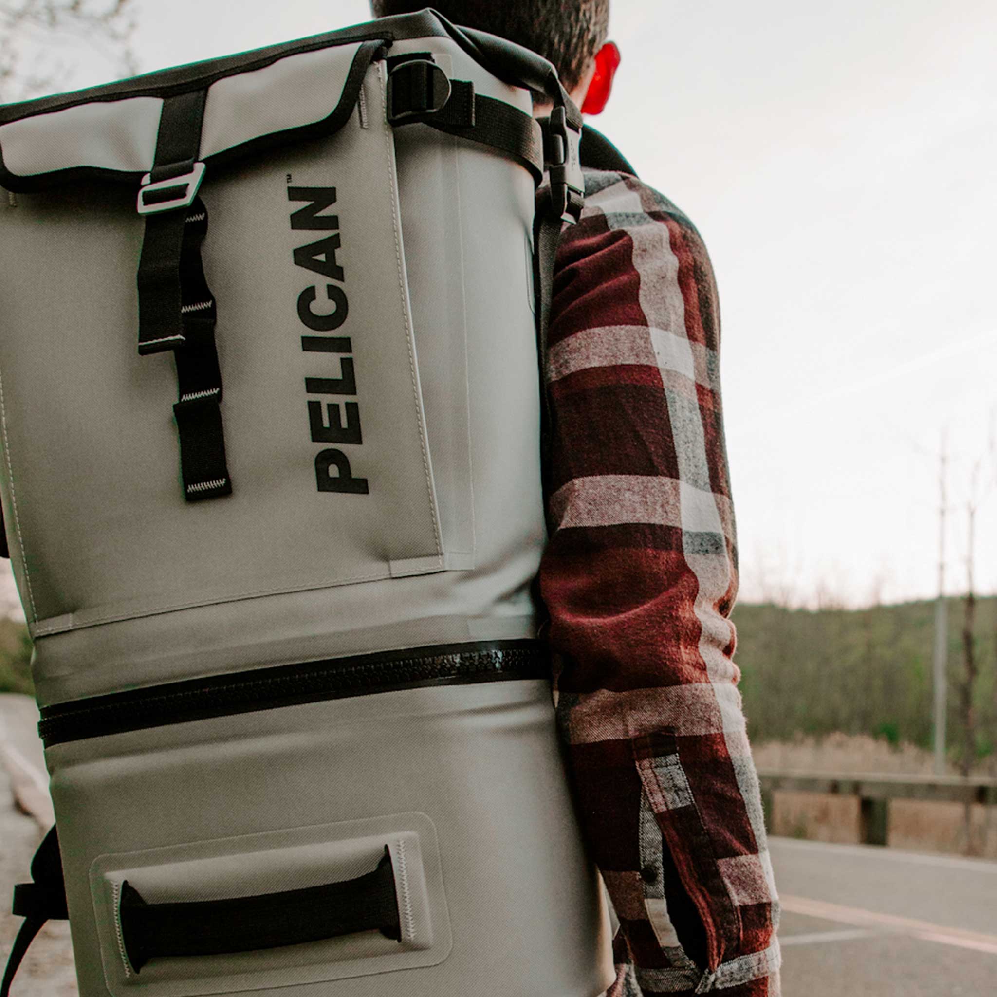 Light Grey Pelican soft cooler backpack on a man's back