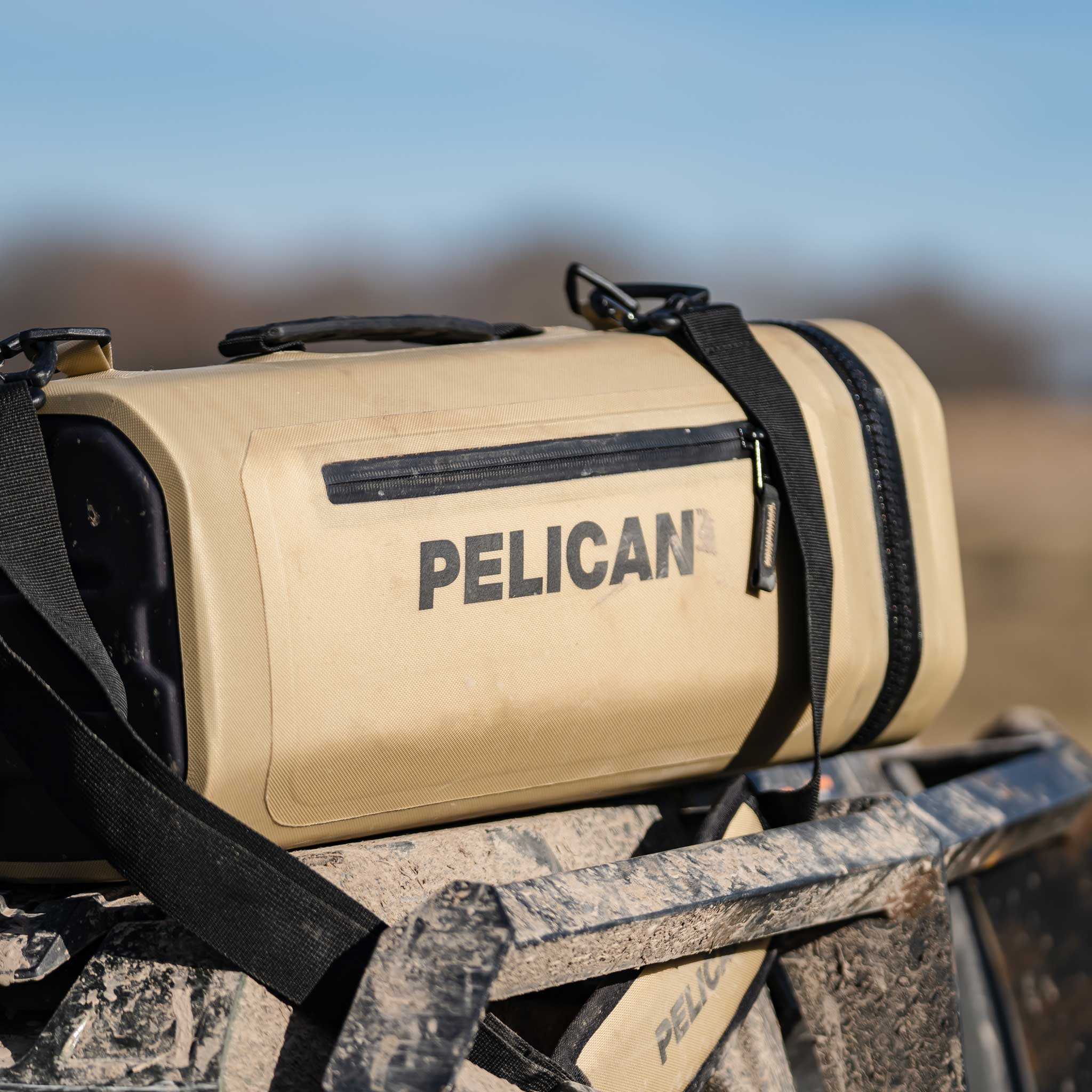 Coyote Pelican™ Dayventure Sling Soft Cooler outside on at ATV
